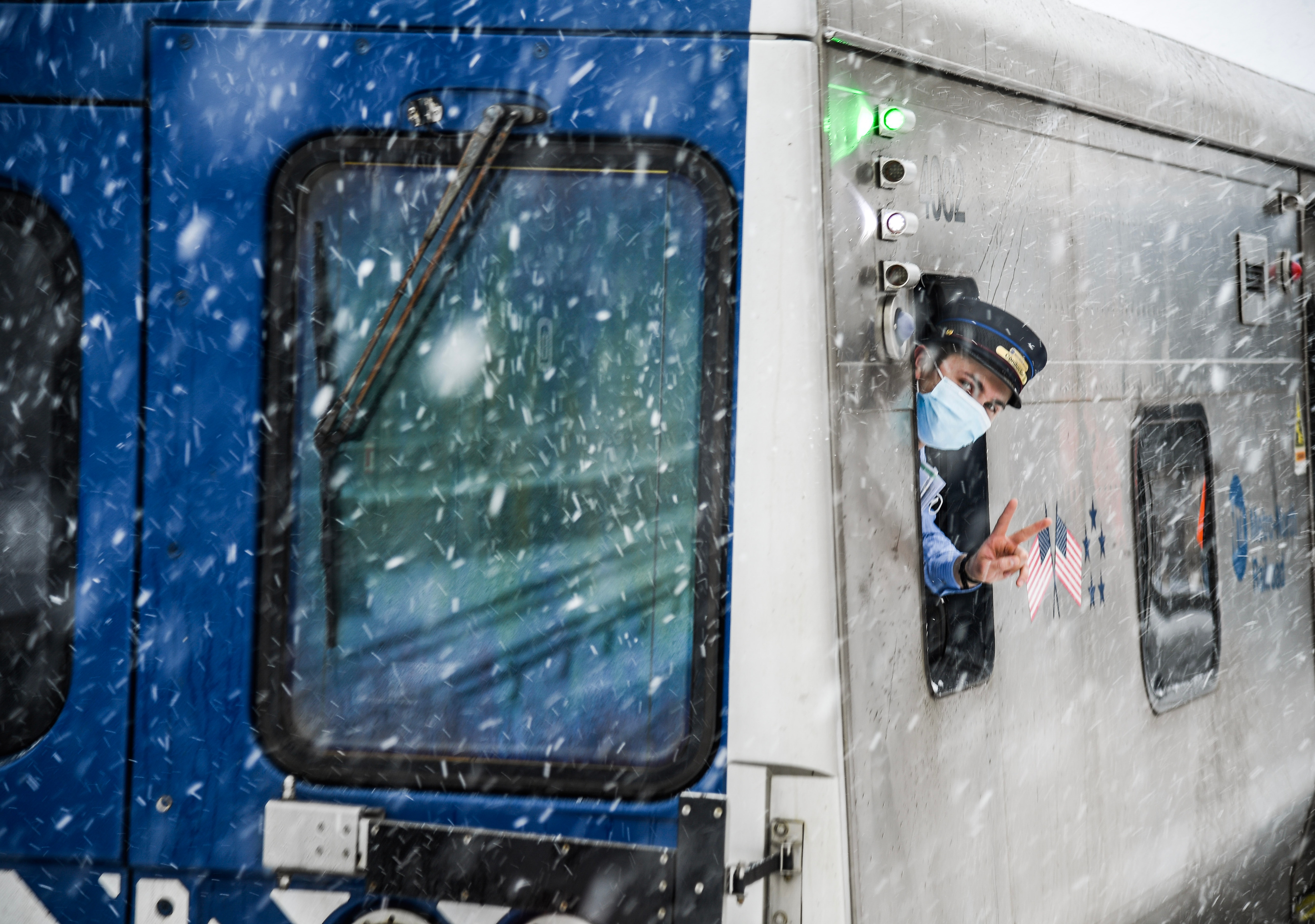 an mta employee on a train during a snowstorm