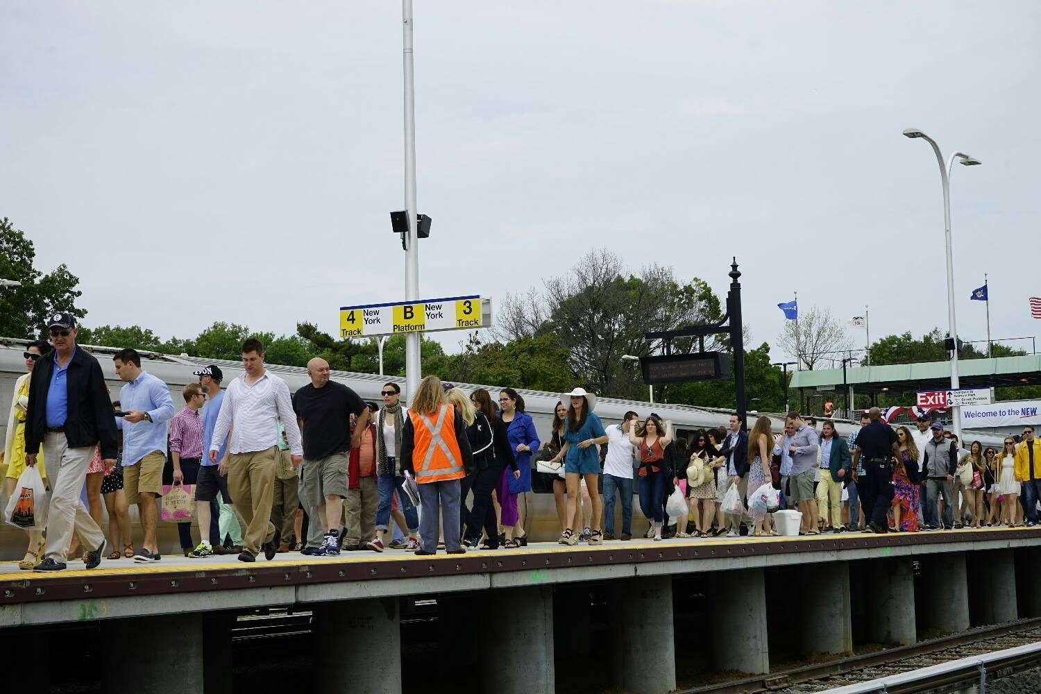 A crowd of people on a train platform.