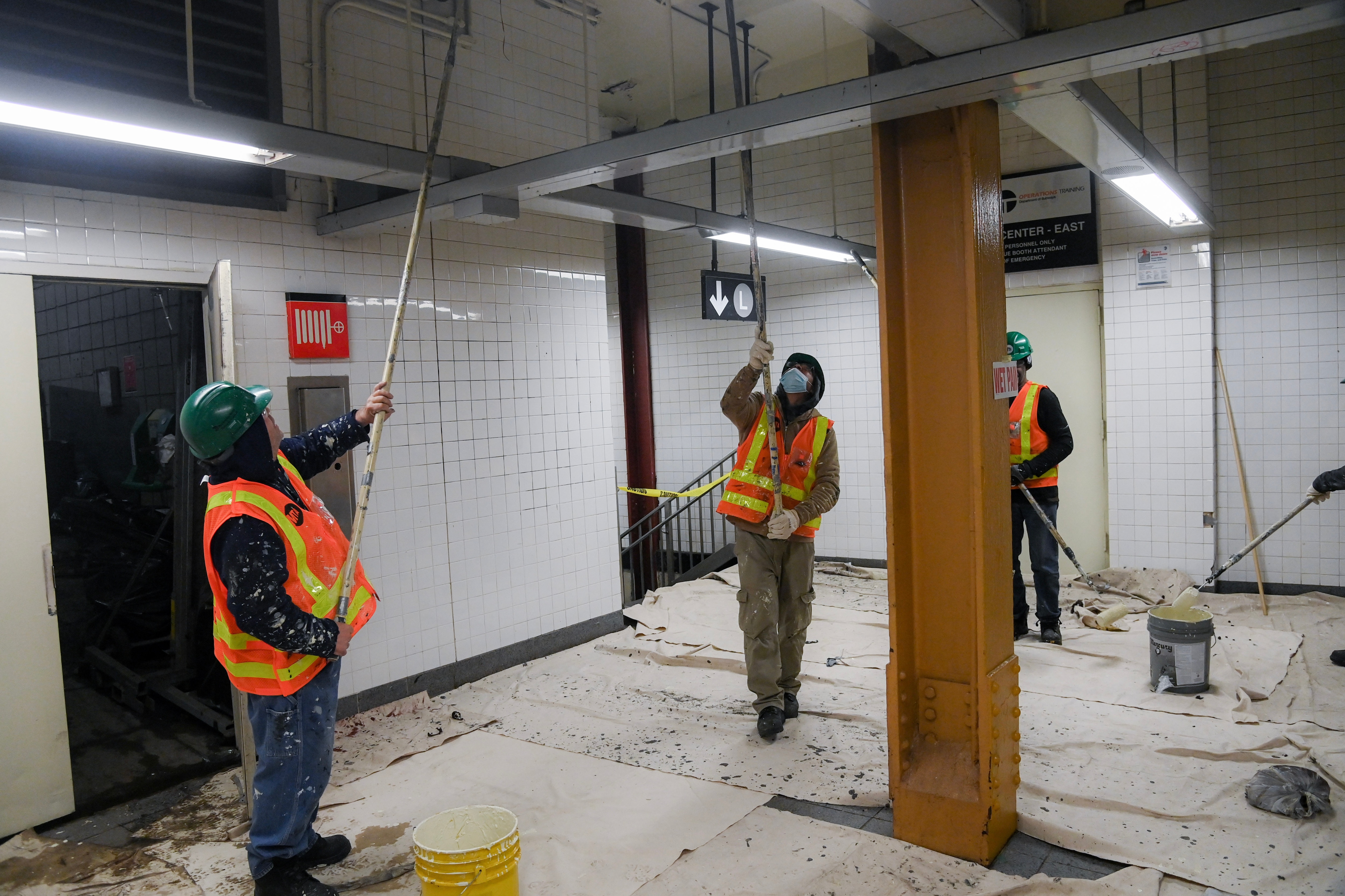 crews painting the ceiling of a subway station as part of the reNEWvation program