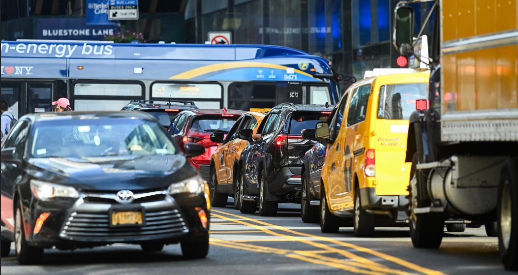Traffic congestion in Manhattan with cars, trucks, taxis, and buses in traffic