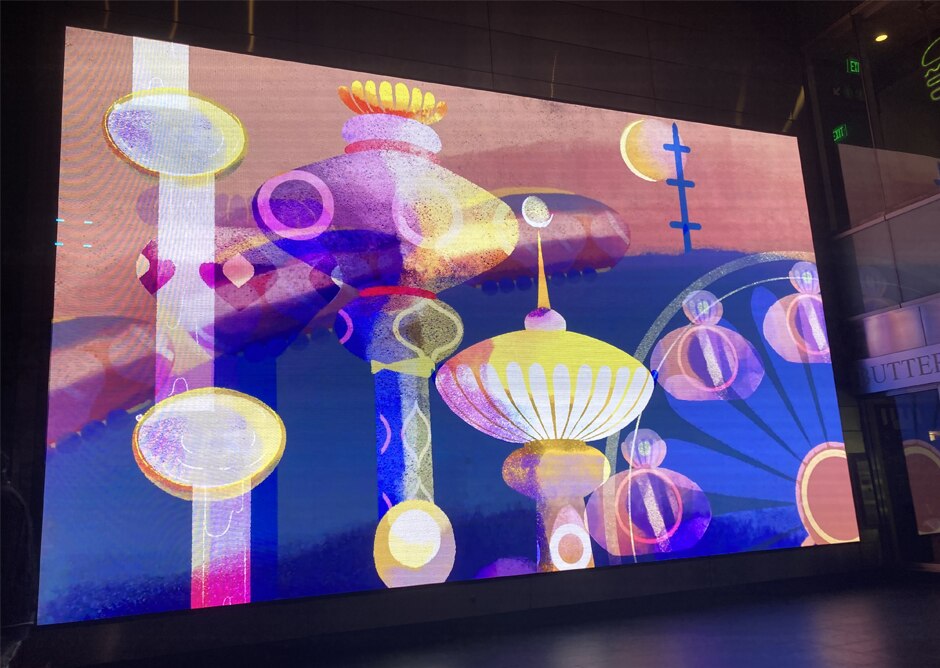 The photo shows digital artwork, "Dream City,” created by Maya Edelman at Fulton Center.  