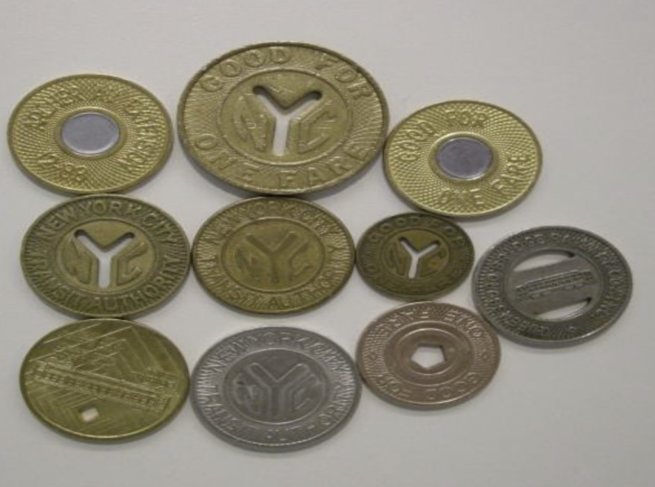 A collection of vintage subway tokens.