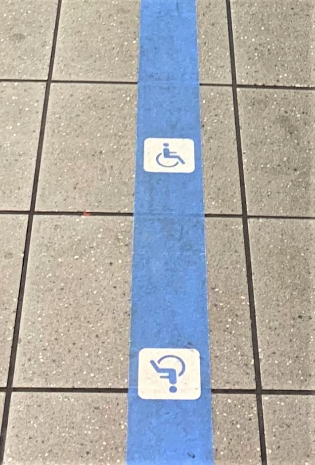 ADA blue tape with ISA symbol on station floor 
