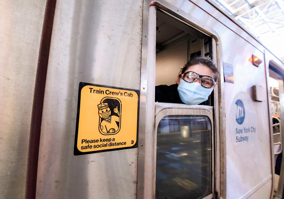 Photograph of a subway conductor near a Train Crew decal