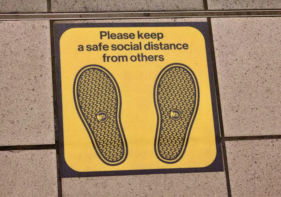 Photograph of a floor decal with sneaker footprints