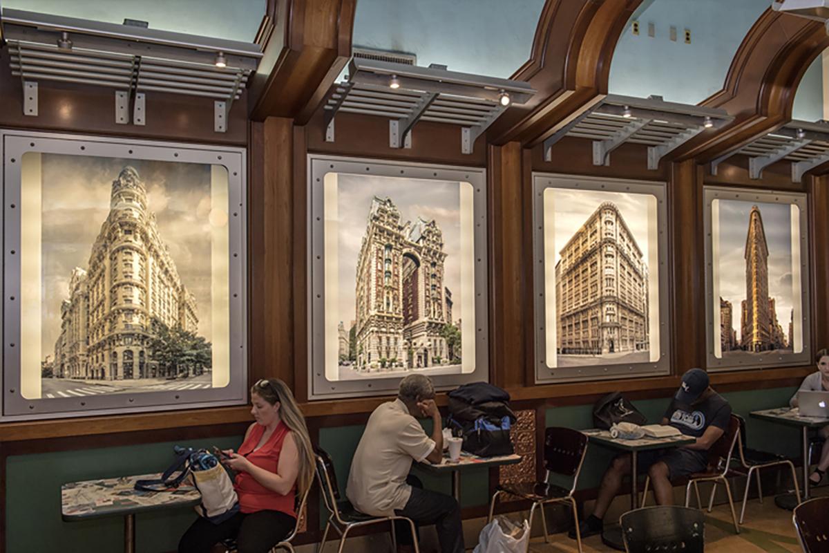 The photo shows photographic artwork, Landmark City, created by Marc Yankus at Grand Central Terminal’s East Dining Course.  