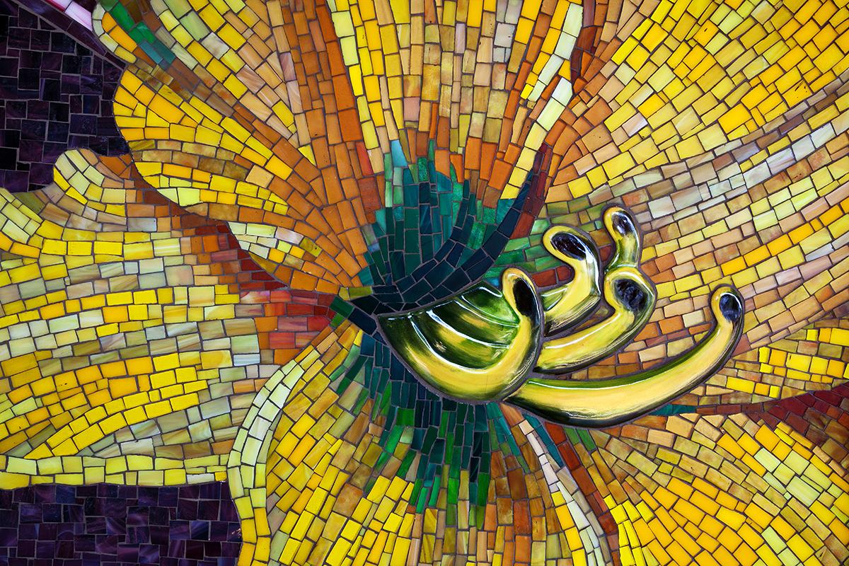 Artwork in mosaic by Jaime Arredondo showing brightly colored flowers. 