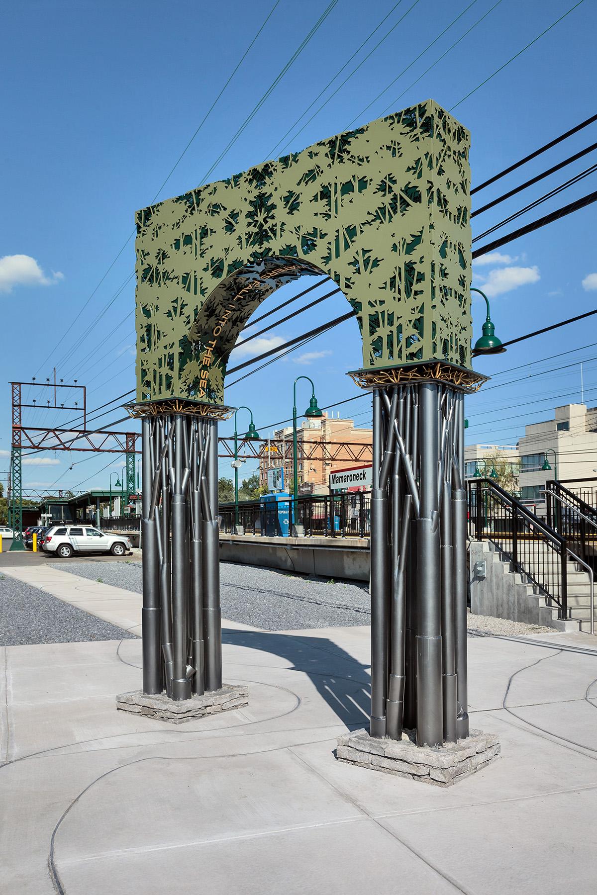 Artwork in steel, aluminum and concrete by Kim Cridler showing a bright green arch. 