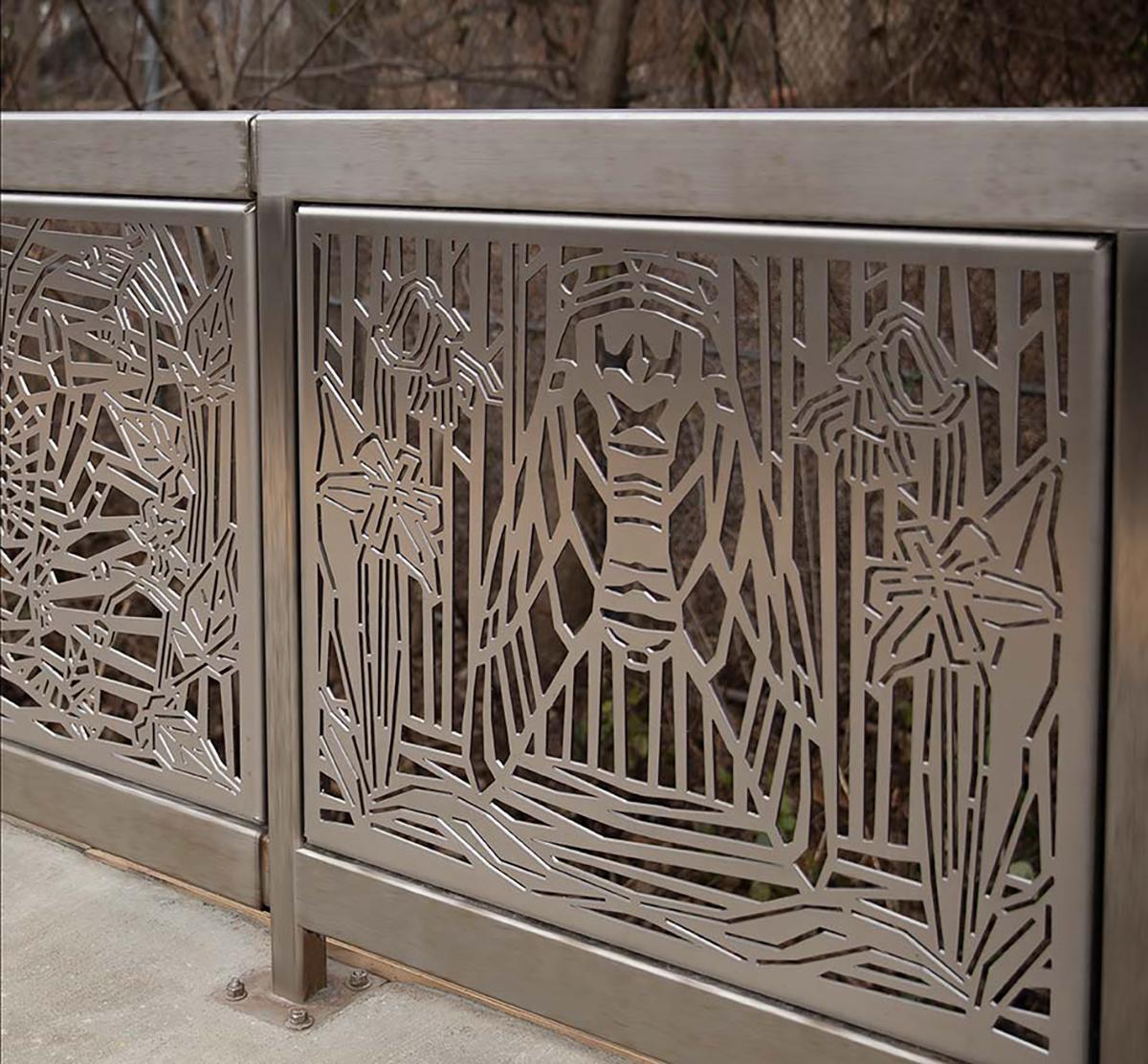 Photograph of metal artwork at SIR Richmond Valley station. The stainless steel artwork panel along the station railing depicts local wildlife and nature.