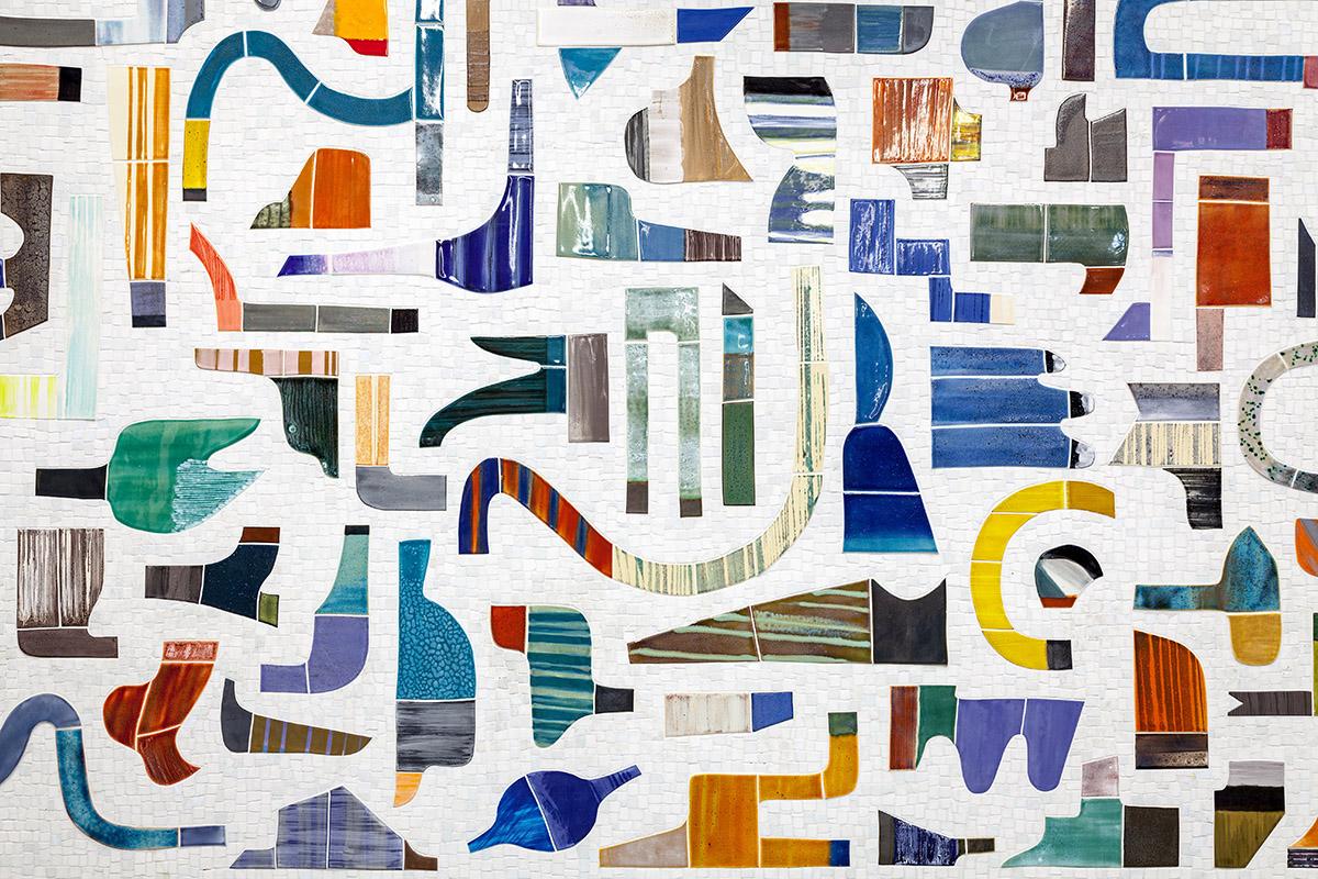Mosaic by Katy Fischer showing many abstract shapes in bright colors on a white background. 