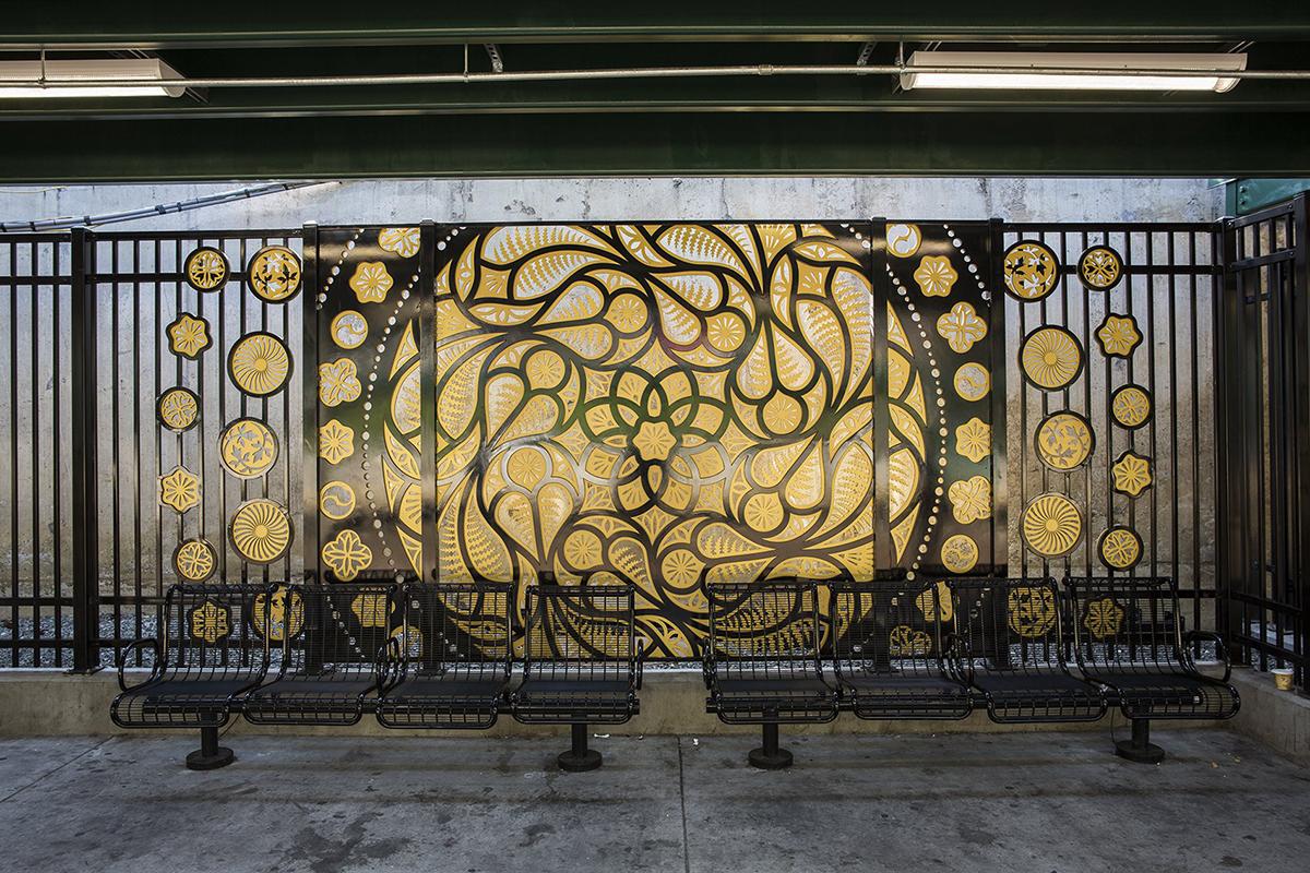 Metalwork wall art by Dan Funderburgh showing fractals and flower designs in bronze and black. 
