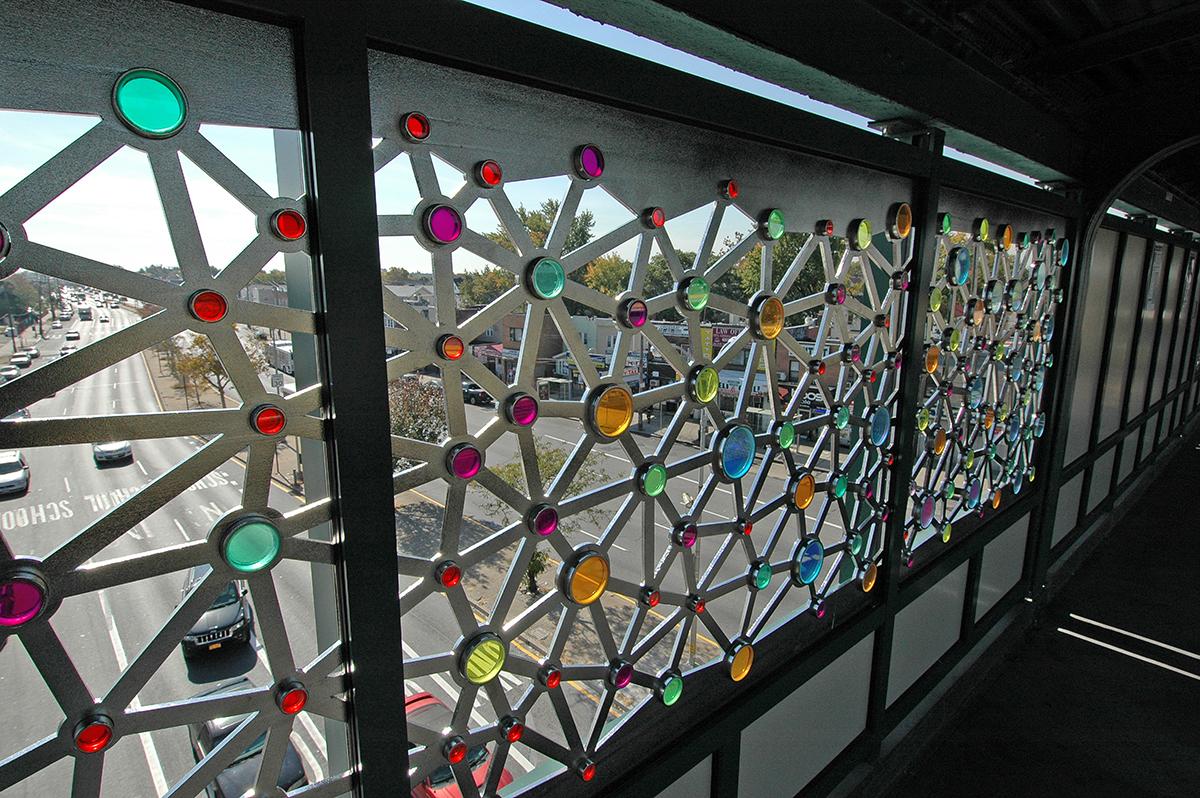 Artwork in metal and glass by Ray King showing circles and lines in an abstract pattern. 
