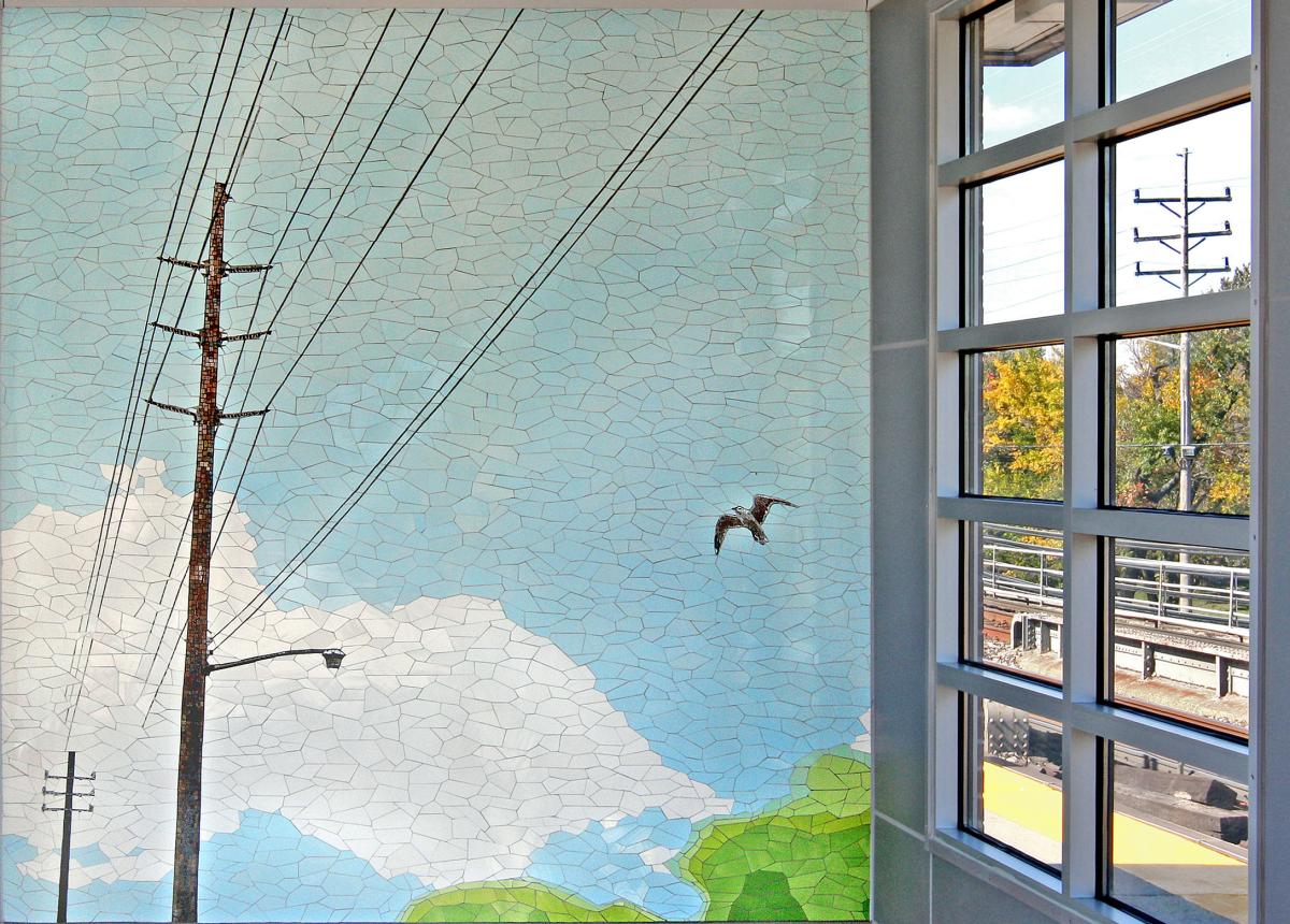 Artwork in glass and ceramic mosaic by Malin Abrahamson showing blue skies and green fields with birds and suburban scenes.
