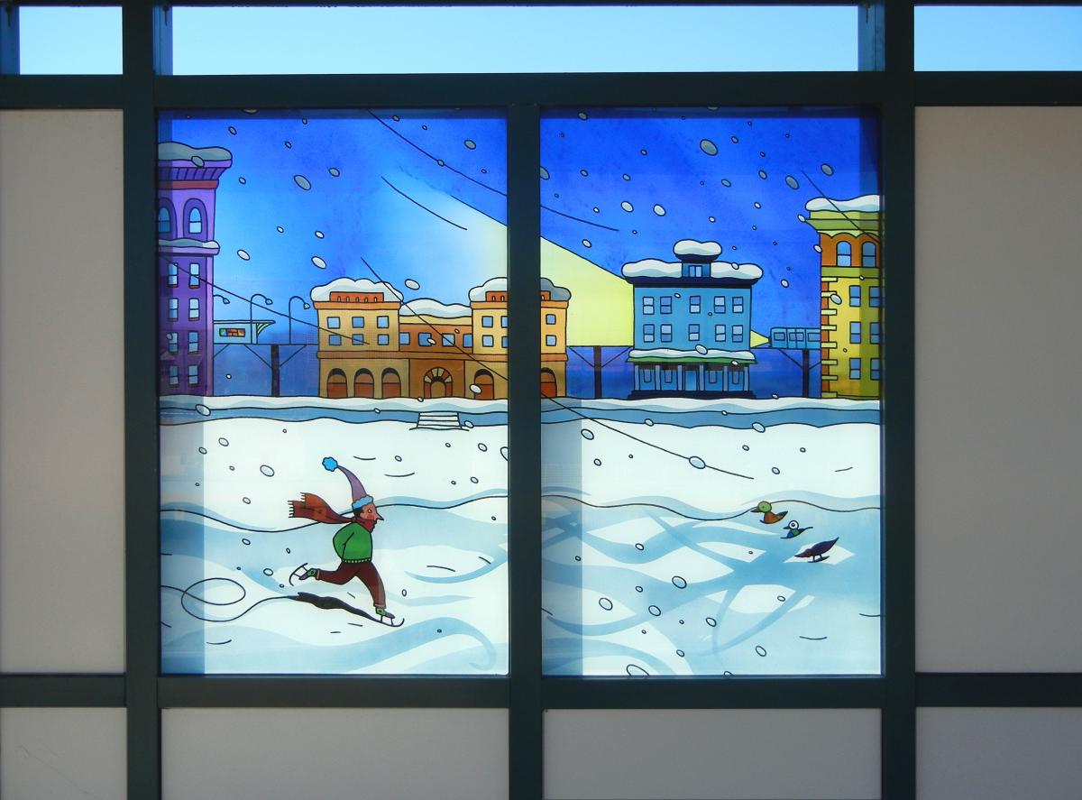 Artwork in laminated glass by Ingo Fast showing figures doing activities like going to the beach, riding a roller coaster, watching fireworks and ice skating.