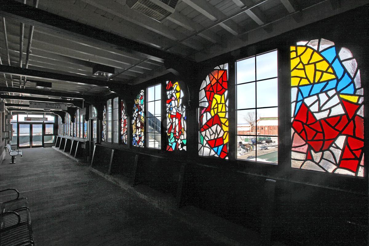 Artwork in faceted glass by Robert Goodnough showing colorful shapes in the station windows.