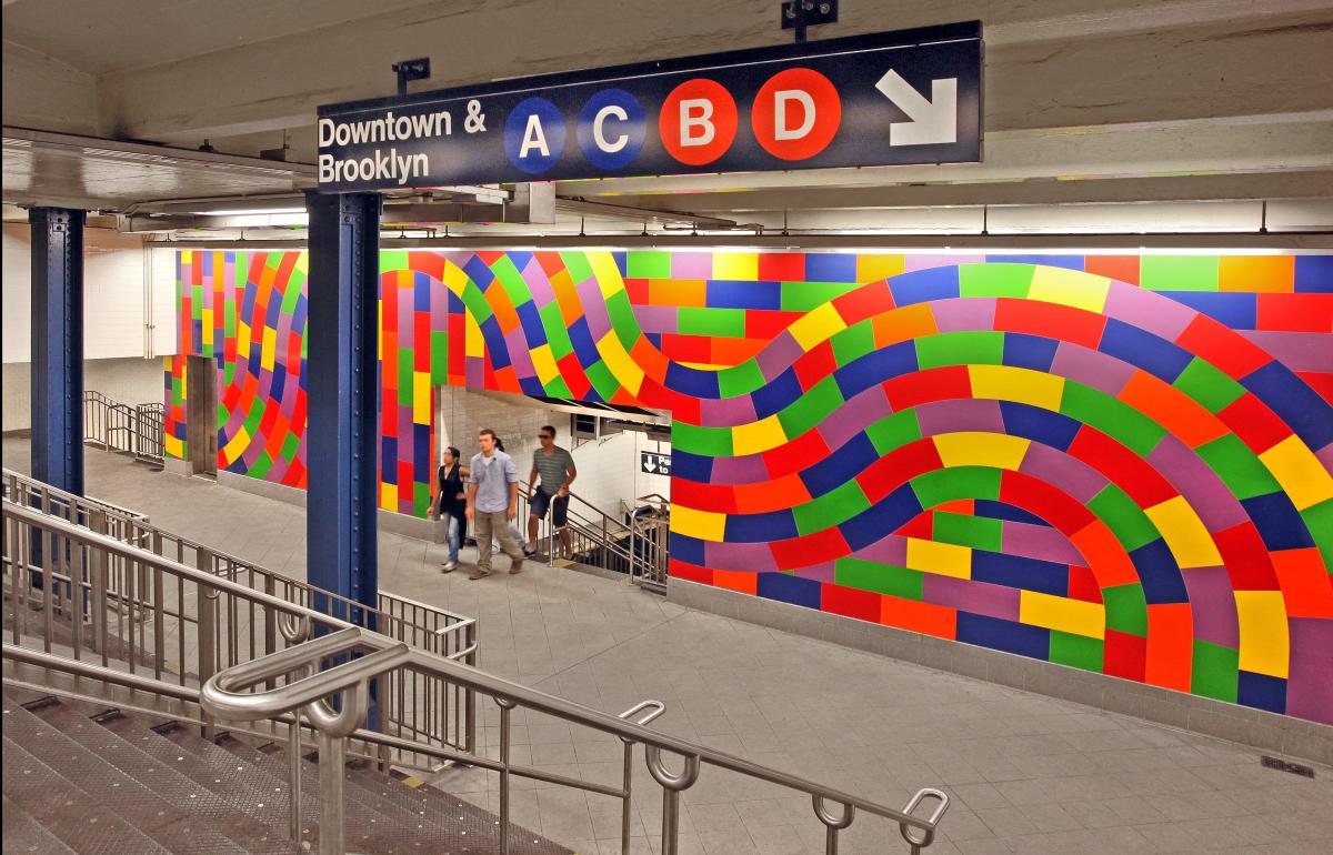 Artwork in porcelain tile by Sol LeWitt showing large colorful linear patterns on the walls and floor.
