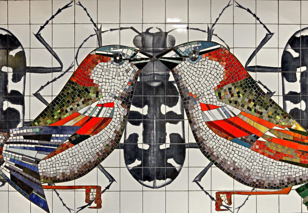 Artwork in glass mosaic and ceramic tile by Ben Snead showing colorful birds and bugs arranged in patterns.