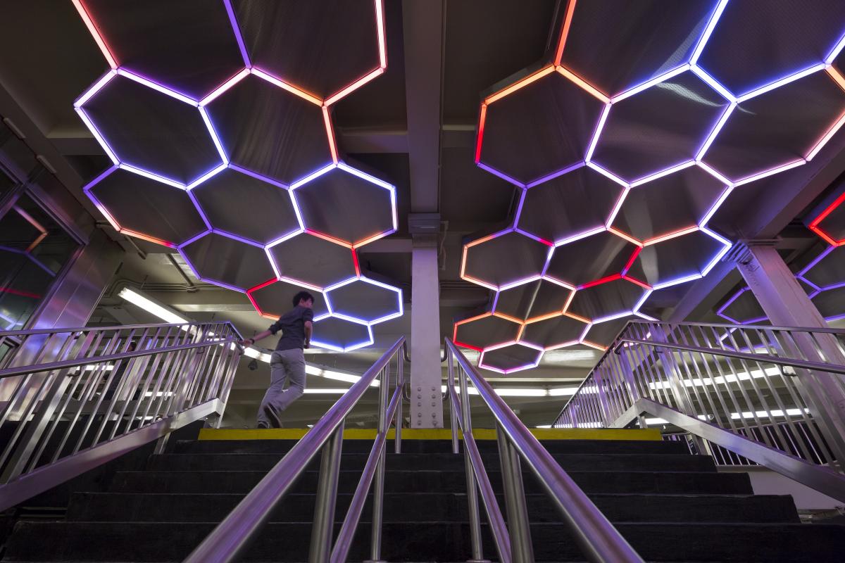 Artwork made from LED tubes by Leo Villareal showing a light sculpture installed in a hexagonal patter on the station ceiling. 