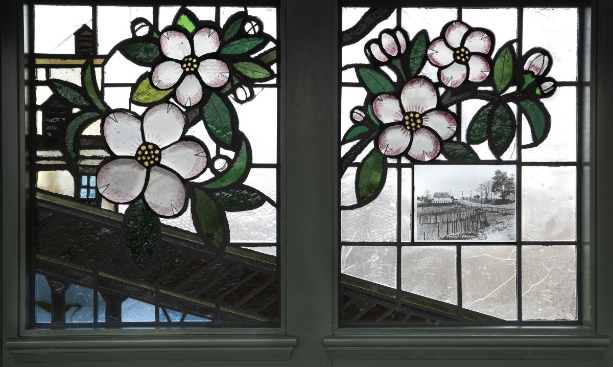Artwork in faceted glass by Tomie Arai showing seasonal floral imagery inset with historic black and white photographs of the area.