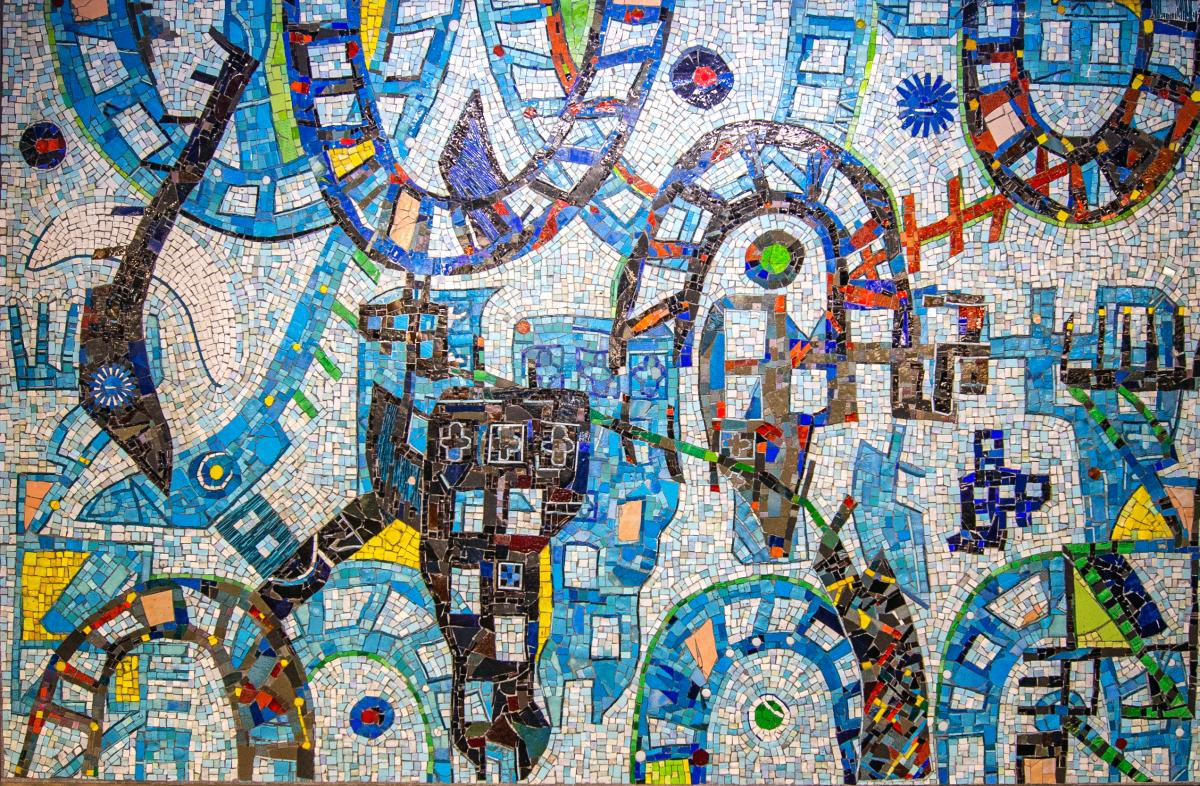 Artwork in glass mosaic by Michael Kelley Williams showing colorful abstract forms on a blue background.