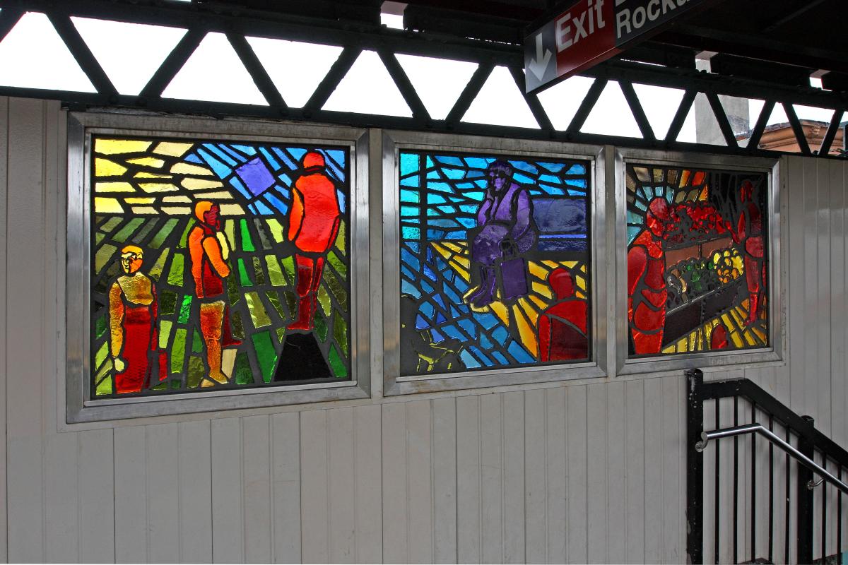 Artwork in faceted glass by Maria Dominguez showing brightly colored scenes of people in the neighborhood. 
