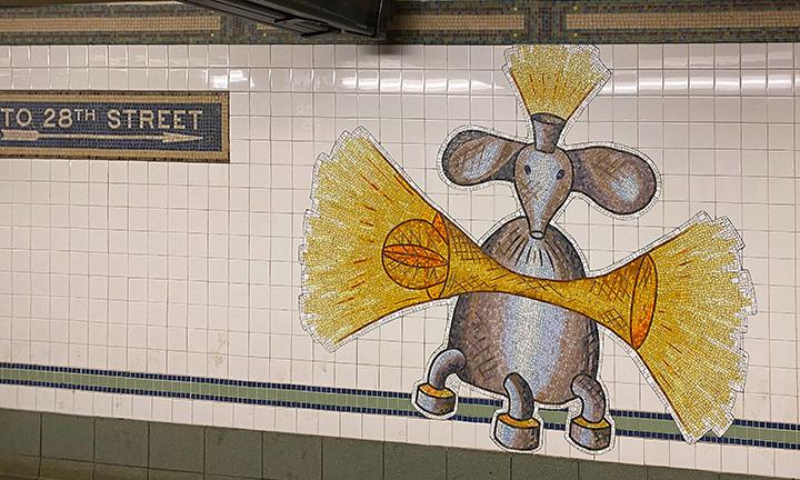 Artwork in glass mosaic by Mark Hadjipateras showing colorful and playful robot-like creatures throughout the station walls. 