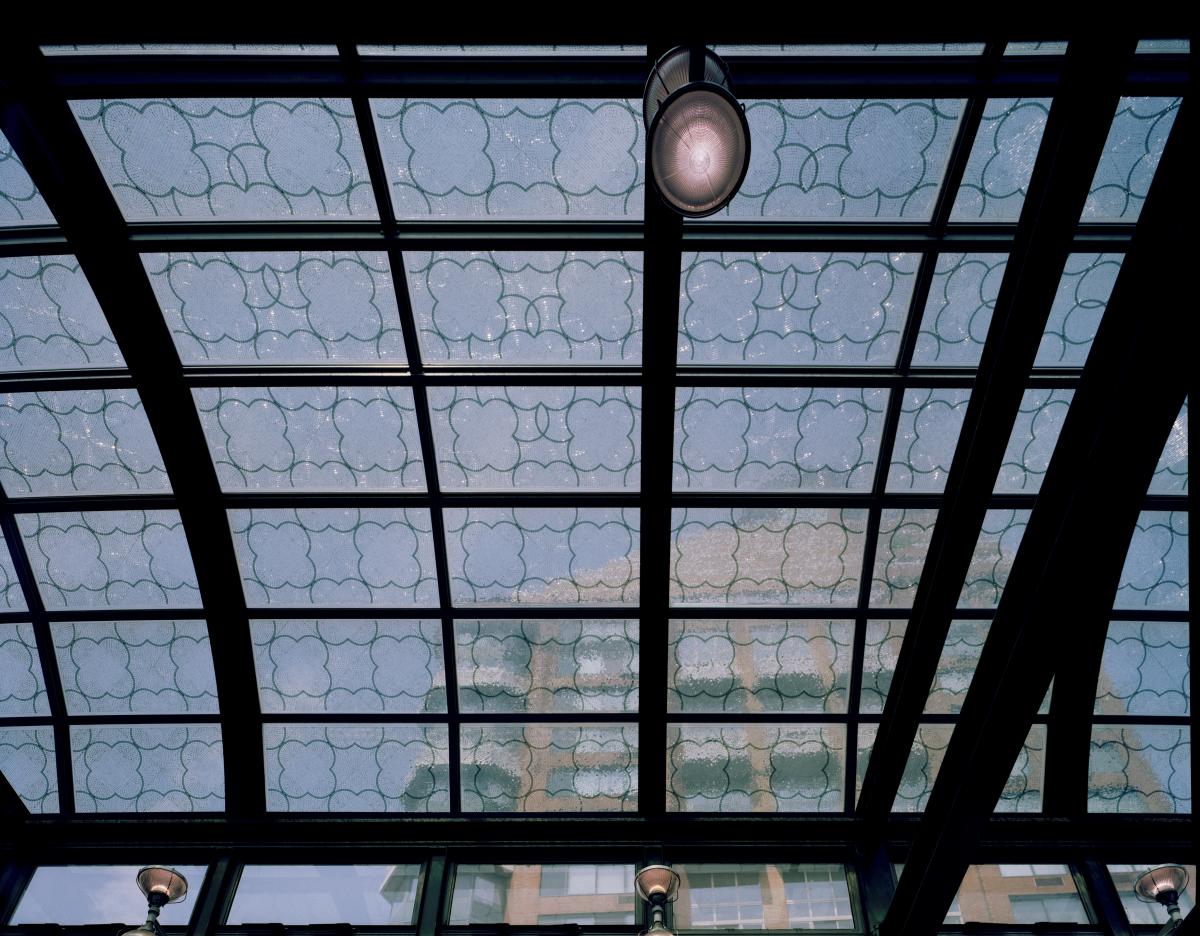 Artwork in mosaic glass by Robert Hickman showing fragmented glass in patterns representing musical notes, installed in the skylight of the subway control house. 