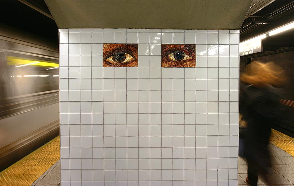 Artwork in mosaic, stone and glass by Kristen Jones & Andrew Ginzel showing eyes and a map of the world.