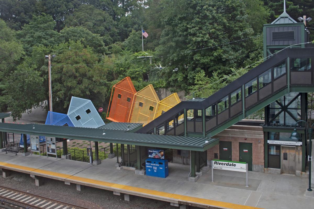 Artwork in perforated painted steel sculpture by Dennis Oppenheim showing low-relief, brightly colored metal sculptures in the shape of four houses. 
