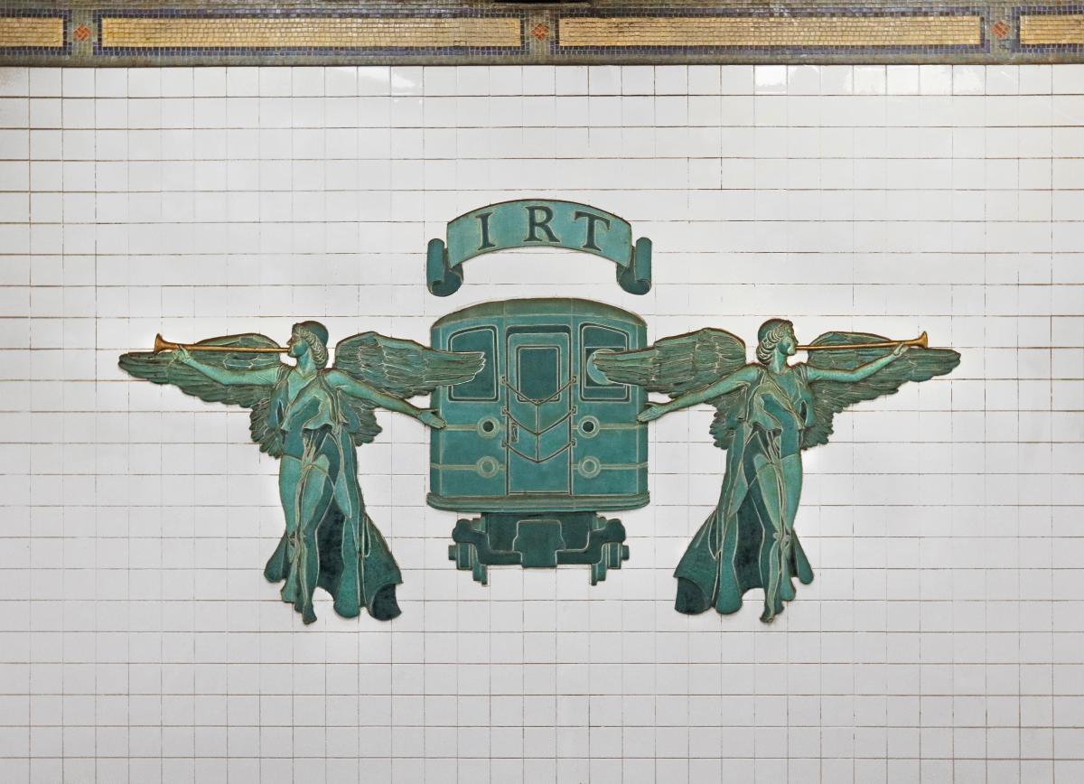 Artwork in bronze and terra cotta by Jane Greengold showing winged figures and train.