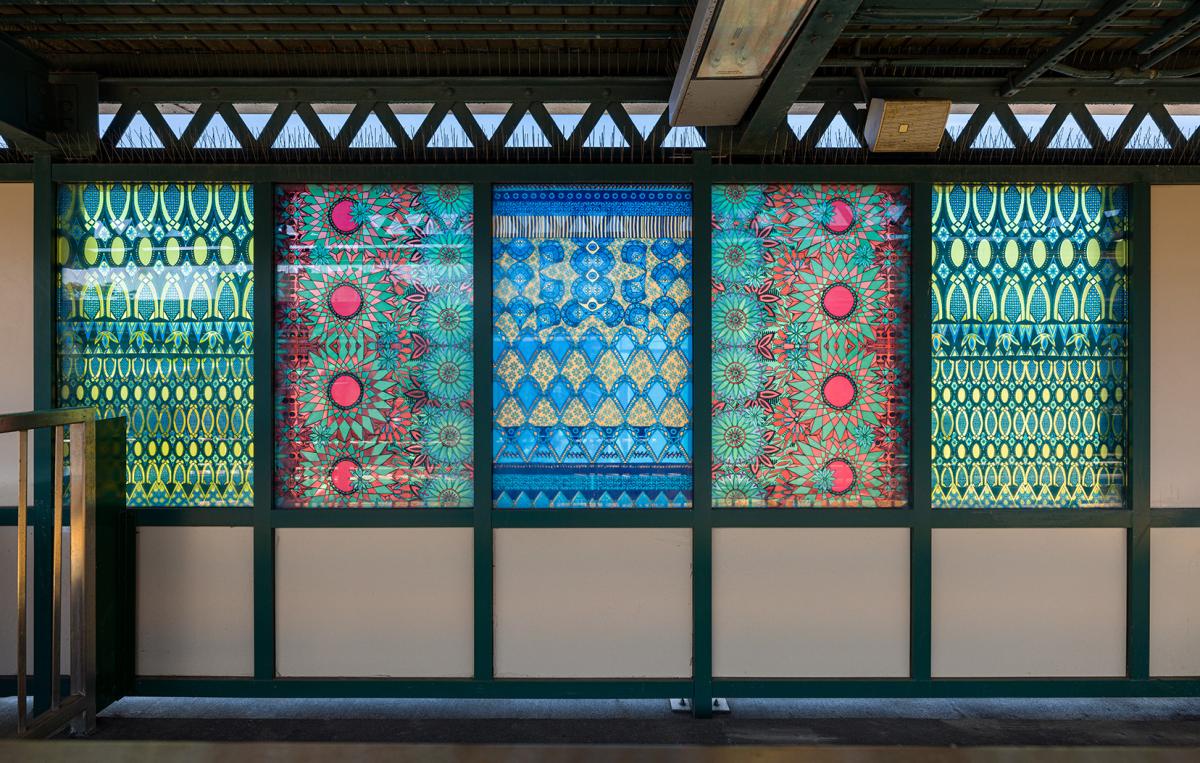 Glass artwork depicting old-fashioned glass patterns in blue, green, and red.