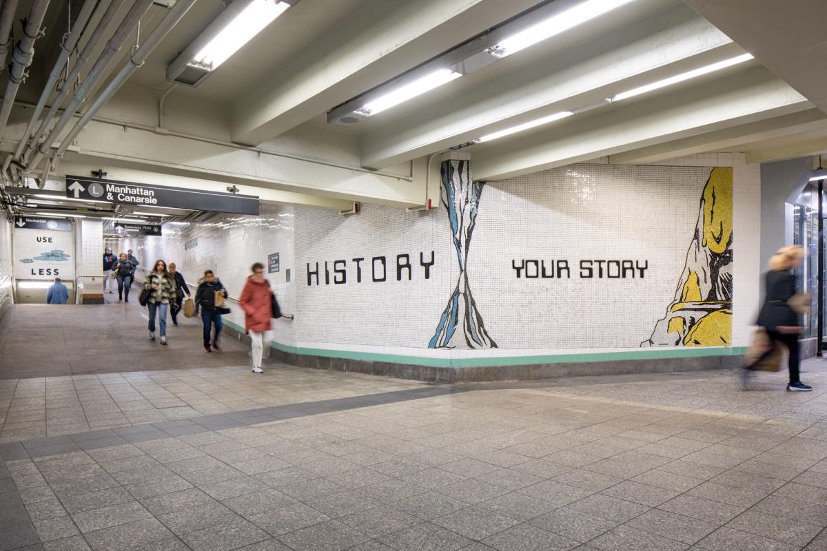 View of station with mosaic artwork with the words "HISTORY" and "YOUR STORY."