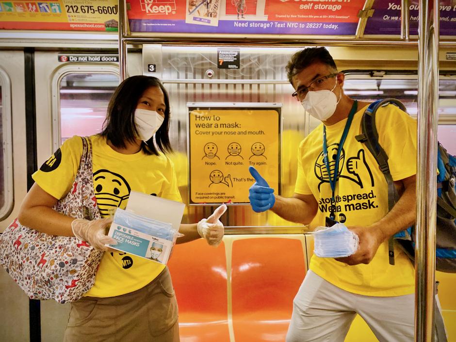 Photograph of two Mask Force volunteers in a subway car