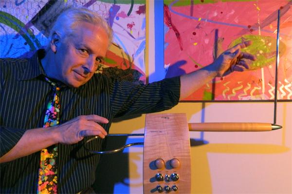 Man with colorful tie playing theremin.