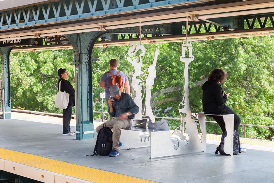 Photo of 18 Ave station platform with Julien Gardair metal sculptural bench artwork on the right with two people sitting on it.