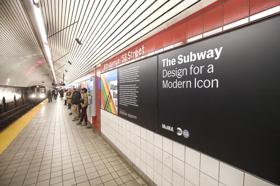 Artwork in vinyl by MTA Arts & Design / The Museum of Modern Art, New York showing the graphic design used within the subway system in colorful shapes and black words. 