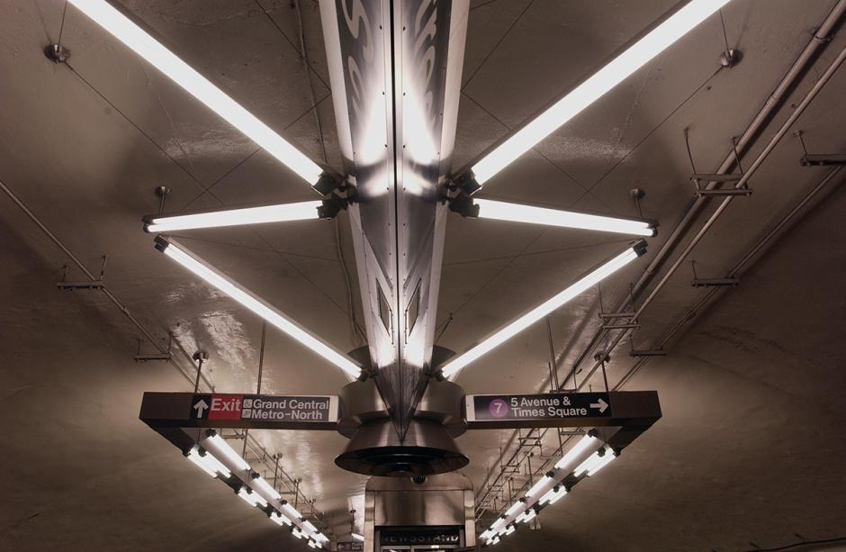 Stainless steel ceiling sculpture by Christopher Sproat on 7 train platform incorporating LED lighting, signage and fan system. 