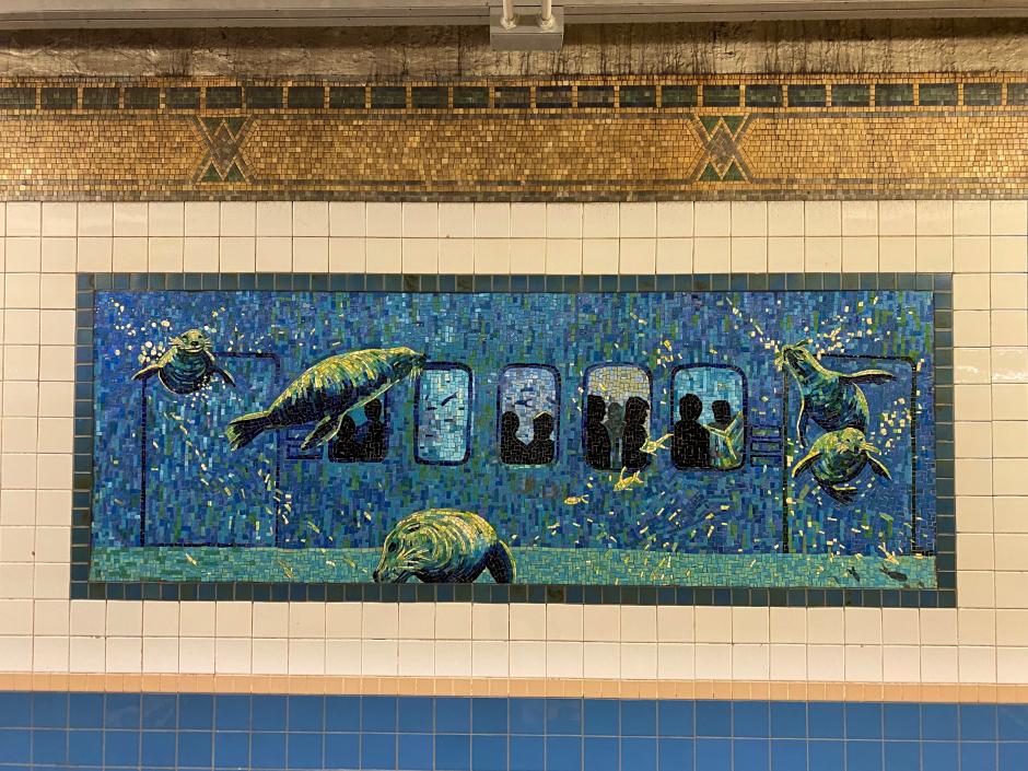 Artwork in glass mosaic by Deborah Brown showing blue aquatic creatures in the subway environment.