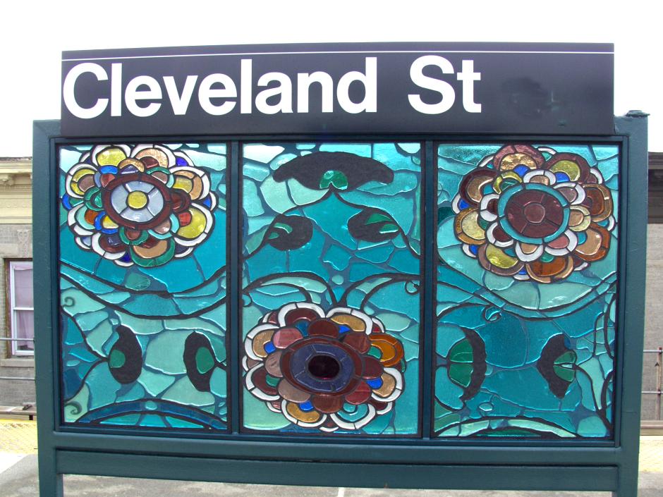 Artwork in faceted glass by Amy Cheng showing colorful floral swirling patterns and motifs.