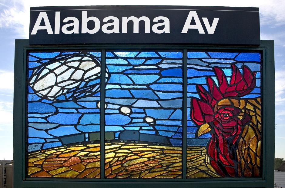 Artwork in faceted glass by Scott Redden showing colorful landscapes.  