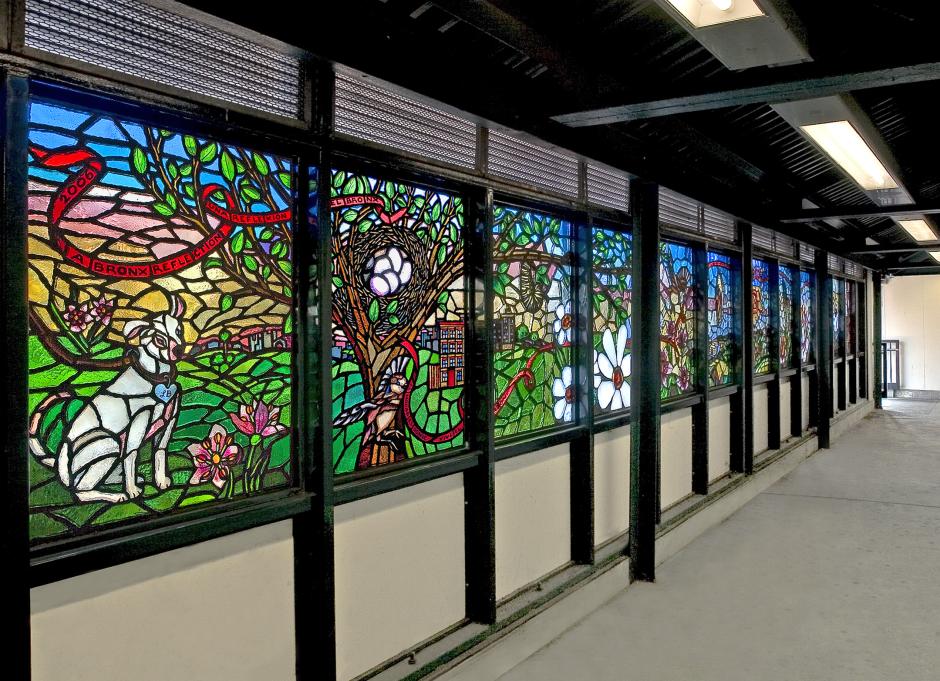 Artwork in faceted glass by Carol Sun showing colorful outdoor scenes and images of home and community life in the Bronx. 