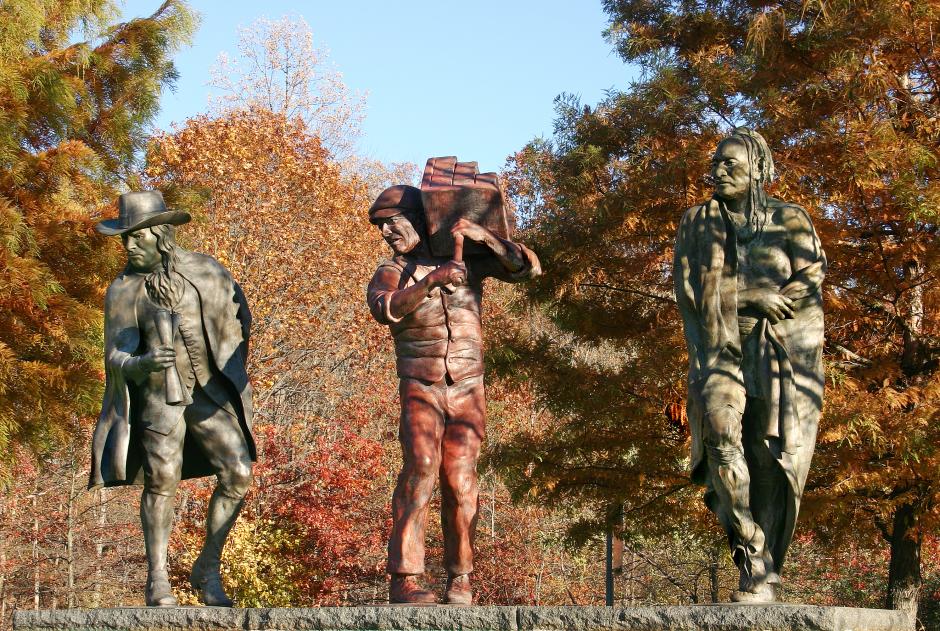 Sculpture in bronze by Robert Taplin showing three figures.