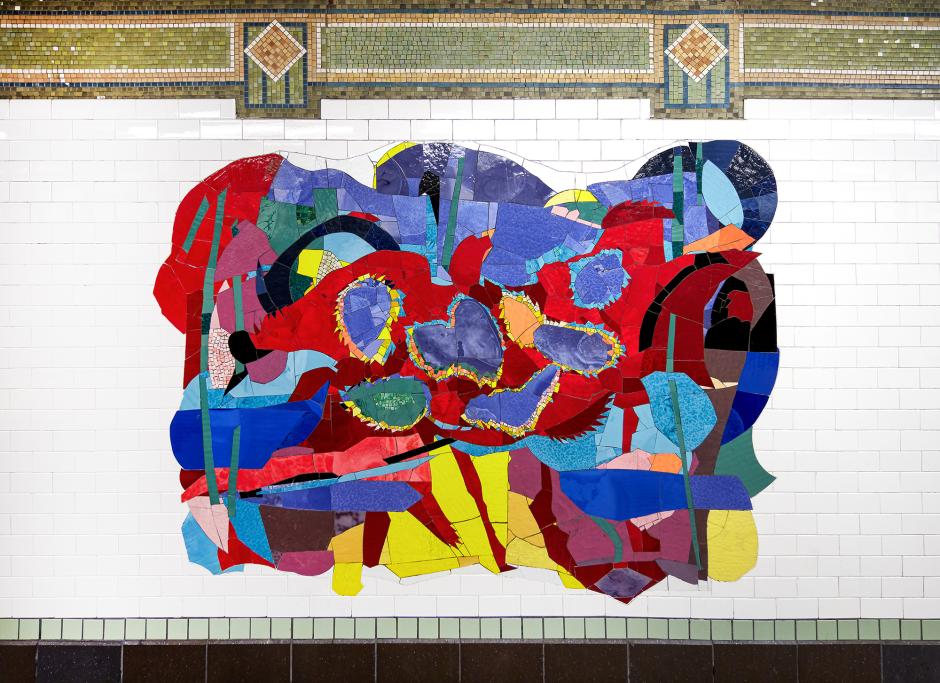 Artwork in glass mosaic by Robert Blackburn showing colorful abstract patterns in large shapes on the platform walls.  