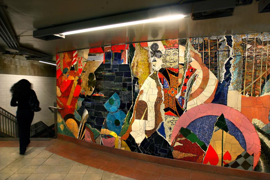Artwork in glass mosaic by Stephen Johnson showing a collage of colors with images of a king, queen, basketball player and piano keys.  