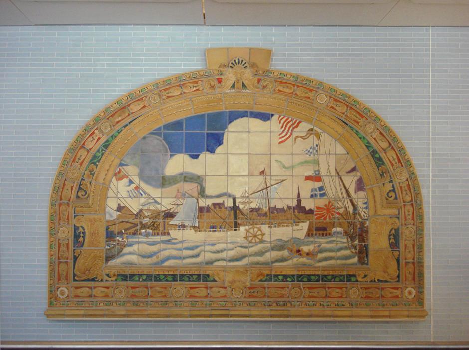 Artwork by Frederick Dana Marsh showing glazed terracotta maritime themed murals above the stairs and a painted cast iron gate at the platform entrance.  