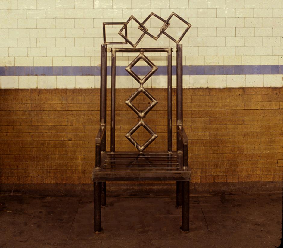 Artwork in steel by Michelle Greene showing an oversized chair on the downtown platform.
