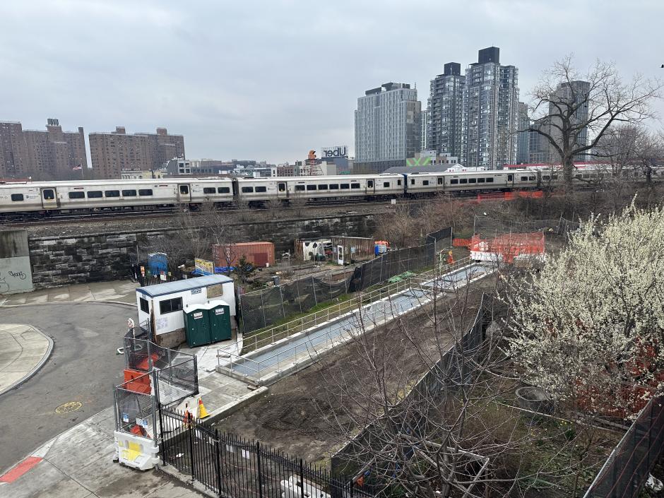 A Metro-North train rolls by on the tracks overlooking La Finca del Sur Community Garden in the Bronx
