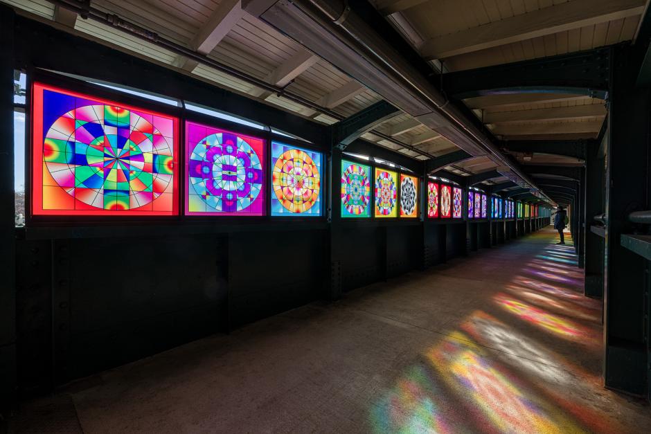 Station hallway with rainbow glass artwork. 