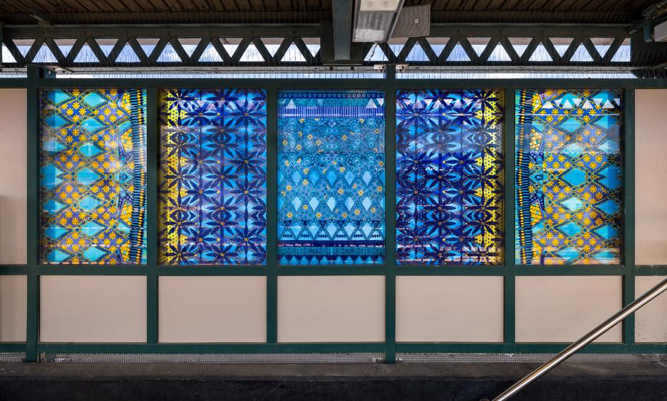 Glass artwork depicting old-fashioned glass patterns in blue and yellow.