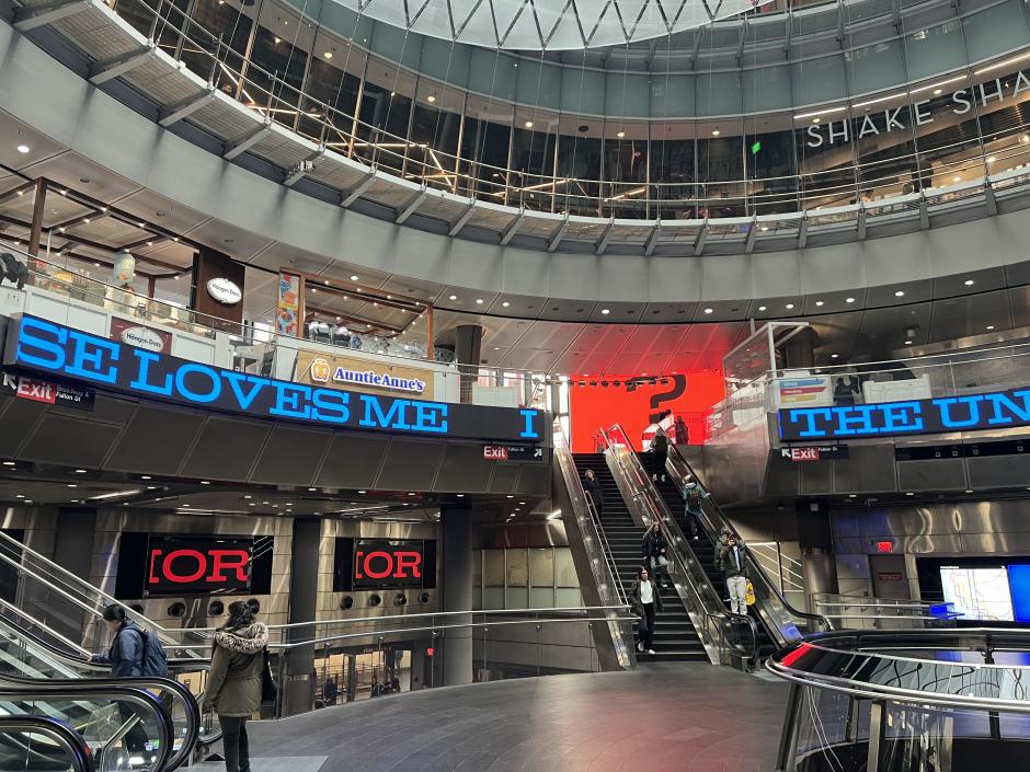 View of Fulton Center with digital artwork on screens. 